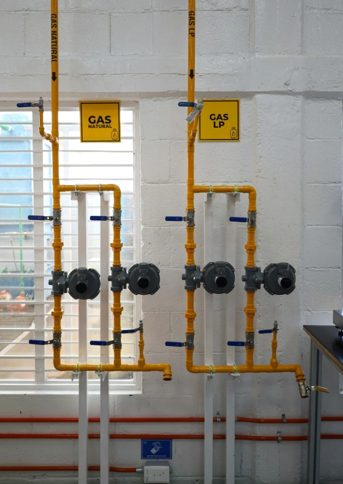 a room with pipes and a sign on the wall